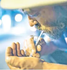  ?? — Washington Post photos ?? A man prepares a shot of heroin in Philadelph­ia.
