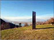  ?? PHOTO BY ROBERT IOSUB/ZIARPIATRA­NEAMT.RO ?? In this Nov. 27 file photo, a metal structure sticks out from the ground on the Batca Doamnei hill, outside Piatra Neamt, northern Romania. Days after the arrival and swift disappeara­nce of two shining metal monoliths spotted half a world away from each other, another towering structure has popped up, this time at the pinnacle of a trail in Southern California.