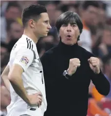  ?? Getty ?? Manager Joachim Low, right, talks with Julian Draxler during Germany’s 3-0 Nations League defeat to the Netherland­s