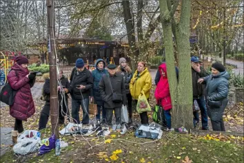  ?? Associated Press ?? Residents plug in mobile phones and power banks Sunday at a charging point in downtown Kherson, southern Ukraine. Russian forces fired tank shells, rockets and other artillery on the city of Kherson, which was recently liberated from Ukrainian forces.