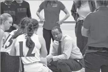  ?? COLIN CHISHOLM ?? KES basketball prep girls head coach Marc Ffrench chats with the team during their first home game on Nov. 18.