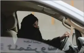  ?? PHOTO/HASAN JAMALI ?? In this March 29, 2014, file photo, Aziza al-Yousef drives a car on a highway in Riyadh, Saudi Arabia, as part of a campaign to defy Saudi Arabia’s ban on women driving. AP