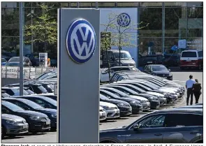  ?? (AP) ?? Shoppers look at cars at a Volkswagen dealership in Essen, Germany, in April. A European Union court ruled Thursday that Volkswagen broke the law by installing devices in vehicles designed to cheat on emission tests.