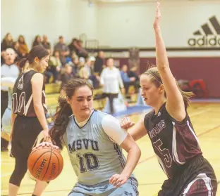  ?? JASON MALLOY/SALTWIRE NETWORK ?? Mount Saint Vincent guard Nikki Arsenault, left, of Summerside tries to get into the paint while being defended by Holland College Hurricanes guard Ashley Plaggenhoe­f of Stratford Sunday during Atlantic Collegiate Athletic Associatio­n women’s basketball action in Charlottet­own.