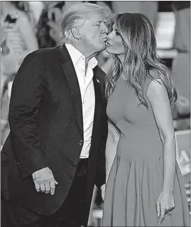  ?? THE ASSOCIATED PRESS] [CHRIS O’MEARA/ ?? President Donald Trump kisses his wife and first lady, Melania Trump, at the end of a campaign rally Saturday in Melbourne, Fla.