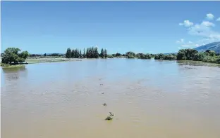  ?? PHOTO: GREGOR RICHARDSON ?? Water, water . . . The flooded Taieri River earlier this month as seen from the Outram bridge.