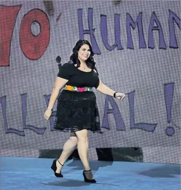  ?? Alex Wong Getty Images ?? ASTRID SILVA walks onstage at the Democratic National Convention. “When Donald Trump talks about deporting 11 million people, he’s talking about ripping families apart — separating families like mine,” she said.