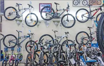  ?? ELI MEIXLER ?? Bicycles for sale are displayed at a Giant Bikes store in central Phnom Penh in 2014.