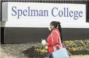  ?? JOHN SPINK Atlanta Journal-Constituti­on / AP ?? A woman walks outside the Spelman campus on Feb. 1 after two historical­ly Black colleges in Georgia received bomb threats. Fort Valley State University and Spelman College were among several HBCUs nationwide that received threats.