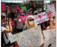 ?? (AP/Orlando Sentinel/Chasity Maynard) ?? Participan­ts wave signs as they walk back to Orlando City Hall during the March for Abortion Access on Oct. 2, 2021.