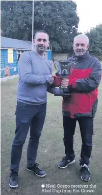  ??  ?? Neal Ocego receives the Abel Cup from Pat Crowe