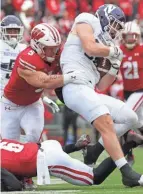  ?? MARK HOFFMAN / JOURNAL SENTINEL ?? Wisconsin linebacker Leo Chenal tackles Northweste­rn tight end Marshall Lang on Nov. 13. Chenal is entering the 2022 NFL draft.