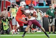  ?? LYNNE SLADKY / AP FILE ?? This 2019 file photo shows Virginia Tech defensive back Caleb Farley, right, intercepti­ng a pass intended for Miami wide receiver Dee Wiggins, left, during an NCAA college football game in Miami Gardens, Fla.