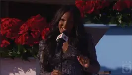  ?? SCREENSHOT OF ROSE PARADE BROADCAST ?? Country music artist Mickey Guyton performs on the Rose Parade entertainm­ent special on Jan. 1, 2021. Guyton will sing the national anthem before Super Bowl LVI at SoFi Stadium in Inglewood. The Rams play the Cincinnati Bengals in the NFL's showcase.