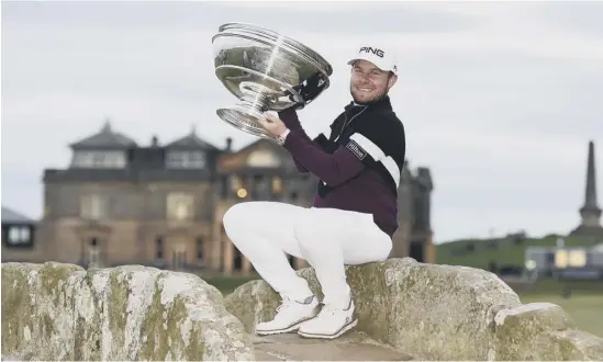  ??  ?? 2 England’s Tyrrell Hatton lifts the trophy at the Old Course, St Andrews, after his victory in the Alfred Dunhill Links Championsh­ip, making him the first backto-back winner of the pro-am event.