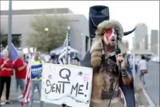  ?? Dario Lopez-MIlls/Associated Press ?? Jacob Anthony Chansley, who also goes by the name Jake Angeli, a QAnon believer known as “QAnon Shaman,” speaks to a crowd of President Donald Trump supporters Nov. 5, 2020, outside the Maricopa County Recorder’s Office in Phoenix.