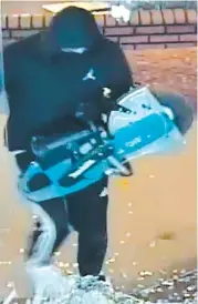  ??  ?? CCTV footage captures one of three offenders using a demolition saw to smash through the front of Warragul’s Telstra store early Friday morning.