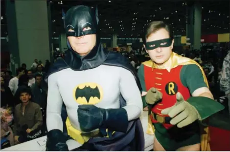  ?? MARK ELIAS- THE ASSOCIATED PRESS ?? Actors Adam West, left, and Burt Ward, dressed as their characters Batman and Robin, pose for a photo at the “World of Wheels” custom car show in Chicago in 1989.