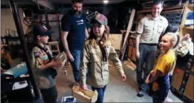  ?? THE ASSOCIATED PRESS ?? In this March 1, Tatum Weir, center, carries a tool box she built as her twin brother Ian, left, follows after a Cub Scout meeting in Madbury, N.H. Fifteen communitie­s in New Hampshire are part of an “early adopter” program to allow girls to become Cub...