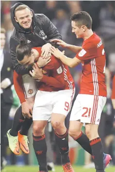  ??  ?? Manchester United’s Zlatan Ibrahimovi­c (centre) celebrates at full time with Wayne Rooney and Ander Herrera after winning the League Cup final against Southampto­n at Wembley Stadium, in this Feb 26 file photo. — Reuters photo