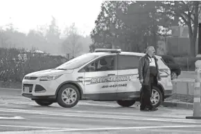  ?? MILWAUKEE JOURNAL SENTINEL ?? A mall security guard is seen near an entrance to Mayfair mall Saturday in Wauwatosa. A gunman opened fire at Mayfair mall in Wauwatosa Friday afternoon, wounding seven adults and one teenager, officials said.