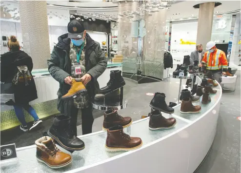  ?? Ryan remiorz / THE CANADIAN PRESS ?? Customers shop for boots as an easing of COVID-19 restrictio­ns allow non-essential stores to reopen Monday in Montreal. Health officials are warning Canadians of the potential for increased contagious­ness of the COVID variants.