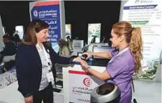  ?? Atiq ur Rehman/Gulf News ?? A delegate is administer­ed a free nutrition test at Al Zahra Hospital’s stand at the health forum in Dubai yesterday.