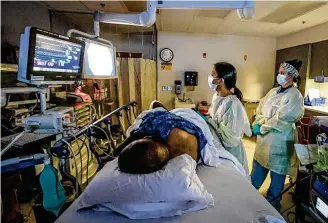  ?? JIM NOELKER / STAFF ?? Dayton VA Dr. Saneeta Agrawal performs a colonoscop­y on Army veteran Vincent Epps using “GI Genius” technology to detect polyps. The RN on the right is Karen Cockerham.