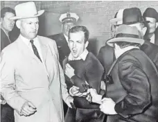  ?? BOB JACKSON, AP ?? Lee Harvey Oswald’s murder by Jack Ruby, right, led to speculatio­n that Oswald was targeted as part of a larger plot.