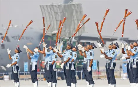  ??  ?? Air Force personnel toss their rifles as they perform during Air Force Day celebratio­ns at the Hindon Air Force Station near New Delhi on Saturday. REUTERS