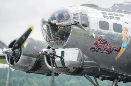  ?? JUSTIN TANG/ THE CANADIAN PRESS ?? Roger Hadfield, father of astronaut Chris Hadfield, waves from the bombardier’s seat after Sentimenta­l Journey, a Second World War B-17 Flying Fortress, lands in Gatineau Monday. ‘It was wonderful,’ the elder Hadfield said later.