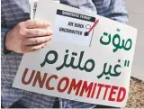  ?? ?? A volunteer’s sign urges voters to vote uncommitte­d and not for Joe Biden in protest over his handling of the Gaza war. Picture: AFP