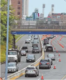  ?? STAFF PHOTOS BY PATRICK WHITTEMORE ?? JUST THE START: Crews work on the Commonweal­th Avenue bridge, left, that spans the Massachuse­tts Pike, above, yesterday. The project is expected to be completed Aug. 11.