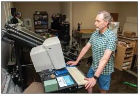  ?? (Arkansas Democrat-Gazette/Cary Jenkins) ?? Clarke Huisman checks an order for framing details.