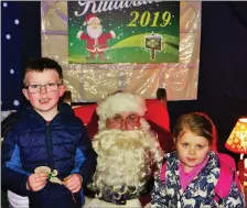  ??  ?? Ronan and Amy O’Farrell meet Santa.