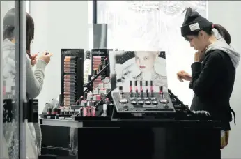  ?? PHOTO: BLOOMBERG ?? Customers browse make-up products at a MAC Cosmetics store, operated by Estee Lauder, in the Omotesando district of Tokyo, Japan. The cosmetics giant lost out to Coty in a bid for Procter & Gamble’s beauty labels last week.
