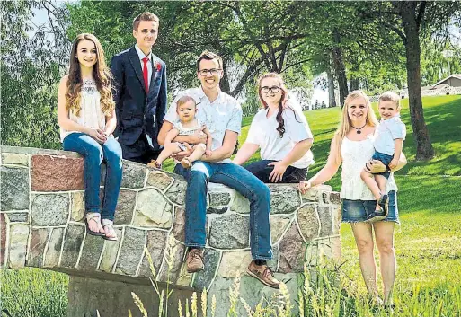  ??  ?? Jill Yahn, far right, is pictured with her family. She says she was told by Heritage all the money she had contribute­d to her son Landon’s RESP was gone.