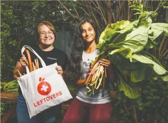  ?? AZIN GHAFFARI ?? Shelby Montgomery, left, vice-president of programs for the Leftovers Foundation, and volunteer Syma Habib display fresh rhubarb from Habib’s garden, some of which will be donated to local charities.