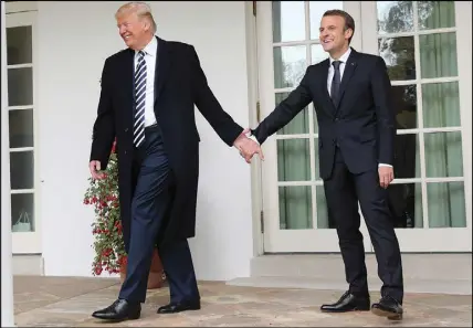  ?? AP PHOTO ?? President Donald Trump and French President Emmanuel Macron walk to the Oval Office of the White House in Washington yesterday.