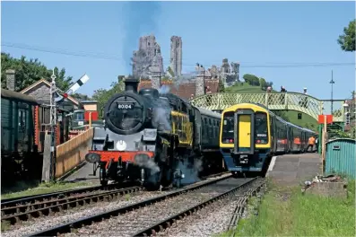  ?? ANDREW P.M. WRIGHT ?? With the second year of trial services to Wareham postponed until 2019, south Western Railway operated a series of ‘summer saturday’ shuttles from the national network to corfe castle from May 26-september 8. one of the toc’s class 159 DMus passes the swanage Railway’s resident bR ‘4Mt’ no. 80104 on June 2.