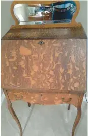  ?? COURTESY ?? Q: I am forwarding a picture of a slant top desk. Can you tell me its approximat­e age and value? Thank you,
— P.R.
A:
This small desk has a bold wood grain.