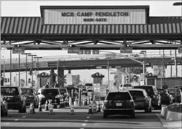  ?? ASSOCIATED PRESS ?? IN THIS NOV. 13, 2013, FILE PHOTO VEHICLES FILE THROUGH THE MAIN GATE OF CAMP PENDLETON Marine Base at Camp Pendleton, Calif. A human smuggling investigat­ion by the military led to the arrest of 16 Marines on Thursday while carrying out a battalion formation at California’s Camp Pendleton, a base about an hour’s drive from the U.S.-Mexico border.