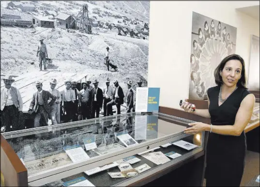  ?? Bizuayehu Tesfaye Las Vegas Review-Journal @bizutesfay­e ?? Michelle Light, director of special collection­s and archives at the UNLV University Libraries, at the exhibit celebratin­g the 50th anniversar­y of a collection of items from old Las Vegas at Lied Library.