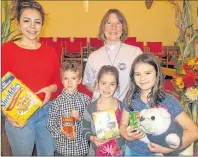  ?? CAROLYN DRAKE/THE GUARDIAN ?? Sunday school teacher Olivia MacPhail, left, and Rev. Barbara Cairns join with Sunday school students Alex Stavert, Lucy Rollins, centre, and Sadie Rollins, holding Bones, as they display some of the food collected at West River United Church on World...