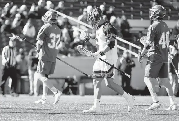  ?? BRIAN KRISTA/BALTIMORE SUN MEDIA GROUP ?? Navy's Greyson Torain pumps his fist after scoring a second-quarter goal against Vermont during Navy’s season-opening win. Torain had five goals and an assist for the Mids.