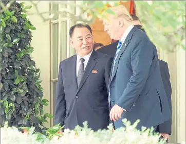  ?? ANDREW HARNIK — THE ASSOCIATED PRESS ?? President Donald Trump talks with Kim Yong Chol, left, former North Korean military intelligen­ce chief and one of leader Kim Jong Un’s closest aides, as they walk from the Oval Office at the White House in Washington on Friday.