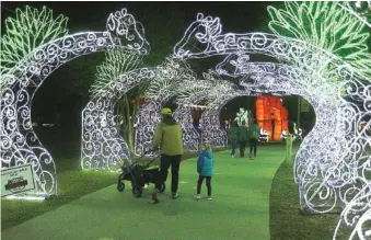  ?? STAFF PHOTOS BY MATT HAMILTON ?? Above: In 2022, visitors walk down a path lit by glowing giraffes as part of the Asian Lantern Festival at the Chattanoog­a Zoo. The festival returns this week beginning at 5:30-9:30 p.m. Thursday.