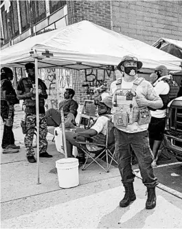  ?? CRAIG LASSIG/AP ?? Volunteers work at a medical station last week near the location where George Floyd died earlier this year while in police custody in Minneapoli­s.