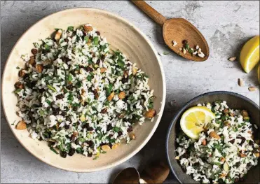  ?? SCRIVANI / THE NEW YORK TIMES ANDREW ?? Bowls of rice salad with currants, almonds and pistachios. Summer buffets often feature potato salad and pasta salad, but rice salad, quite popular throughout the Mediterran­ean, is another terrific option to keep in mind.