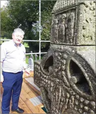  ??  ?? John Devitt from the Monasterbo­ice Tour Guides and right, Muiredach’s Cross under wraps.